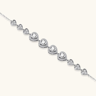 Complete jewelry set with heart-shaped sterling silver pieces featuring brilliant moissanite stones on white background.