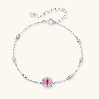 Sterling silver jewelry set featuring pink moissanite stones in halo settings on white background.